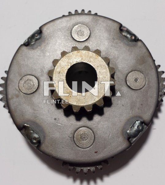 Ümmargune metallplaat, mille keskel on tippgeaar, millel on teravad hambad. Plaadi ümber on mitu väikest ringikujulist detaili, mis on ühtlaselt jaotatud. Taga on nähtavad keevitusmärgid.