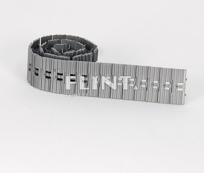 A gray plastic strip coiled into a spiral. The strip features distinct ridges and notches for ease of installation and adjustment.