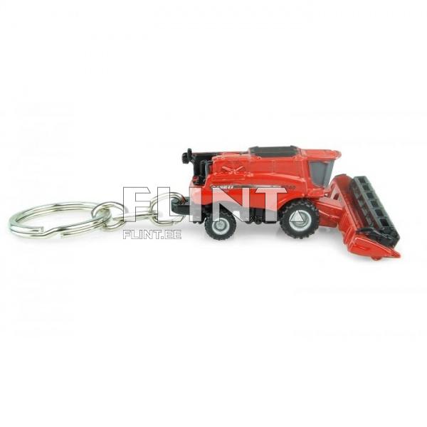 A red miniature model of a combine harvester with detailed design and working wheels. The model is attached to a keychain, allowing for easy portability.
