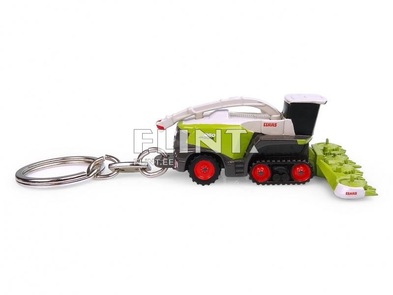 A miniature harvester with a green and black body, red wheels, and a white top. The CLAAS logo is visible on the sides.