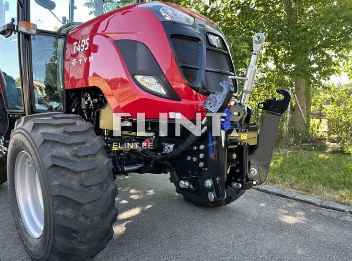 The red T495 tractor is shown with a large, rugged axle and thick tires. The front panel features vents for airflow, and a rear attachment is visible.