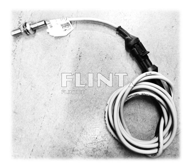 The product is a white cable featuring a metal end and a black plastic connector. The cable is coiled and has a product label attached.